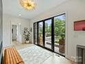 Bright living room with a wall of glass doors and modern accents at 112 Manning Dr, Charlotte, NC 28209