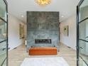 Modern living room featuring a striking stone fireplace and light wood floors at 112 Manning Dr, Charlotte, NC 28209