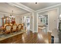 Elegant dining room with hardwood floors, chandelier, and adjoining living spaces at 118 Tuscany Trl, Mooresville, NC 28117