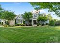 Attractive two-story home with manicured lawn and mature trees at 118 Tuscany Trl, Mooresville, NC 28117