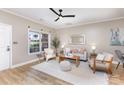 Cozy living room with neutral walls, a ceiling fan, and plenty of natural light at 121 Quality Dr, Mount Holly, NC 28120