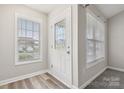 Bright entryway featuring a stylish front door with glass detailing and updated flooring and fresh paint at 1305 Dan Dr, Rock Hill, SC 29732