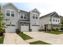 Desirable townhome with two-car garage, stone accents, and a manicured lawn at 13327 Savaine St, Charlotte, NC 28278