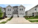 Attractive townhome with two-car garage, neutral siding, and well-kept landscaping at 13327 Savaine St, Charlotte, NC 28278