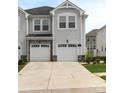 Charming townhome showcases garage, stone accents, and well-maintained landscaping for enhanced curb appeal at 13327 Savaine St, Charlotte, NC 28278