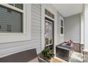 Inviting front porch features comfortable seating, stylish accents, and a welcoming entrance at 13327 Savaine St, Charlotte, NC 28278