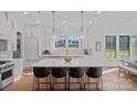 Spacious, white kitchen with a large center island, modern appliances, and pendant lighting at 1405 Waxhaw Marvin Rd, Waxhaw, NC 28173