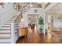 Bright foyer with grand staircase, hardwood floors, and views into the living spaces at 167 Quaker Rd, Mooresville, NC 28117