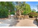 Custom outdoor kitchen with stone pizza oven, grill, and seating area is an entertainer's dream at 167 Quaker Rd, Mooresville, NC 28117