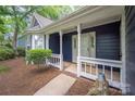 Inviting front porch with white columns and railing, and meticulous landscaping at 172 Valleybrook Dr # 8, Denver, NC 28037