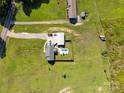 An aerial view displays the property, a swimming pool, and the surrounding grassy landscape at 2268 Westbrook Rd, Edgemoor, SC 29712