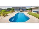 Inviting backyard featuring a freeform pool, surrounded by lounge chairs and tropical landscaping at 2268 Westbrook Rd, Edgemoor, SC 29712