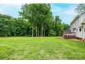 Large backyard with mature trees, offering plenty of space for outdoor activities at 2728 Touchstone Cir, Newton, NC 28658