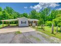 Home exterior featuring a covered parking area, a well maintained lawn, and mature trees at 286 Southside Rd, Rock Hill, SC 29730