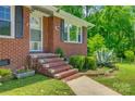 Brick home entrance with steps, complemented by mature greenery and a walkway at 286 Southside Rd, Rock Hill, SC 29730