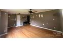 Spacious living room featuring hardwood floors, a ceiling fan, and a cozy electric fireplace at 286 Southside Rd, Rock Hill, SC 29730