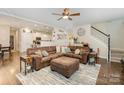 The expansive living room is open to the kitchen and features hardwood floors and neutral paint colors at 35 Dorie Dr, Belmont, NC 28012