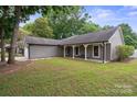 Spacious ranch-style home with well-manicured lawn, covered porch, and attached garage at 3807 Sweetgrass Ln, Charlotte, NC 28226