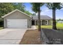 Attractive ranch-style home with a welcoming front porch and attached two-car garage at 3807 Sweetgrass Ln, Charlotte, NC 28226
