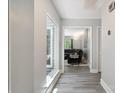 Inviting hallway with wood flooring and ample natural light leading to the living area at 3807 Sweetgrass Ln, Charlotte, NC 28226