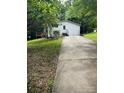 Exterior view of home featuring a concrete driveway and partially wooded lot at 4006 Hillview Dr, Shelby, NC 28152
