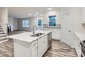 Bright kitchen featuring an island sink, white cabinetry, and stainless steel appliances at 4404 Dusty Orchard Rd, Kannapolis, NC 28081