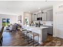 Modern kitchen with a large island, gray cabinets, and seating, perfect for entertaining at 4415 Dusty Orchard Rd, Kannapolis, NC 28081