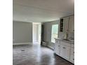 Living room with laminate floors, neutral paint, and access to the eat-in kitchen at 4417 Grier St, Gastonia, NC 28056