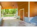 Spacious carport area with stairs leading to front entry at 4524 Cinderella Rd, Charlotte, NC 28213