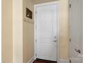 Bright entryway featuring a white door with coat hooks and dark wood flooring at 4620 Piedmont Row Dr # 308, Charlotte, NC 28210