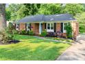 Beautiful brick home showcasing a well-maintained lawn, mature trees, and a welcoming pathway at 4924 Farm Pond Ln, Charlotte, NC 28212