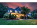 Charming home with covered front porch, manicured lawn, and professional landscaping for curb appeal at 5044 Dockside Ct, Matthews, NC 28104