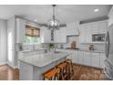 Bright kitchen featuring white cabinetry, a large island with bar seating, and stainless steel appliances at 5044 Dockside Ct, Matthews, NC 28104