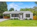 Charming home with a well-manicured lawn, a carport, and inviting curb appeal at 605 Cobb St, Lowell, NC 28098