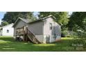 Back exterior of a home featuring a wooden deck, stairs and walk out basement at 608 E E St, Newton, NC 28658