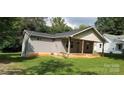 View of home's exterior with tidy landscaping and a covered front porch area at 608 E E St, Newton, NC 28658