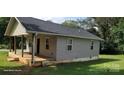 Shows the exterior side of the home with a cozy porch and steps to the yard at 608 E E St, Newton, NC 28658