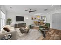 Cozy living room with modern furniture, stylish decor, and plenty of natural light and seamless flow into the dining area at 6518 Point Comfort Ln, Charlotte, NC 28226