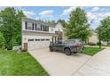 A two-story home featuring a white exterior, stone accents, driveway, and landscaped front yard under a cloudy sky at 6726 Carradale Way, Charlotte, NC 28278