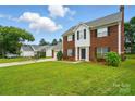 Charming brick two-story home with a well-manicured lawn and an attached two-car garage at 6821 Millingden Ct, Charlotte, NC 28277