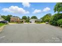 Quiet street featuring single Gathering homes each with well maintained lawns and mature trees at 6821 Millingden Ct, Charlotte, NC 28277