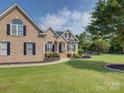 Beautiful brick home featuring a manicured lawn, landscaping, and a walkway leading to the entrance at 736 Creekbridge Dr, Rock Hill, SC 29732