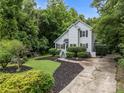 Charming home with a concrete driveway, a lush lawn, and manicured landscaping at 7830 Sarah Dr, Denver, NC 28037