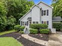 Charming home featuring a manicured front yard with a lighted pathway leading to the front door at 7830 Sarah Dr, Denver, NC 28037