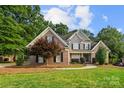 Attractive two-story home with a brick facade, complemented by a lush green lawn at 9219 Whispering Wind Dr, Charlotte, NC 28277