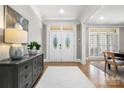 Elegant foyer with hardwood floors, a decorative mirror and a stained glass double-door entryway at 9219 Whispering Wind Dr, Charlotte, NC 28277