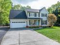 Beautiful two-story home with an attached garage, a well-maintained lawn, and a welcoming front porch at 107 Ingonish Dr, Gastonia, NC 28056