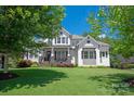 Beautiful two-story home featuring a covered porch, stone accents, and manicured landscaping at 1085 Wessington Manor Ln, Fort Mill, SC 29715