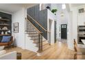 Inviting foyer showcasing modern staircase with wood treads and black railings, and a contrasting accent wall at 11024 Shreveport Dr, Huntersville, NC 28078