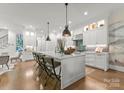 Bright kitchen with white cabinets, updated appliances, and a spacious center island perfect for entertaining guests at 1160 S Kings Dr, Charlotte, NC 28207